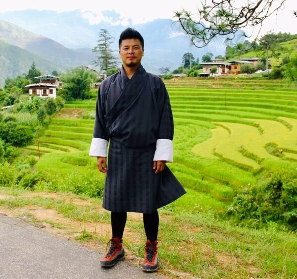 Person in traditional attire, rice terraces.
