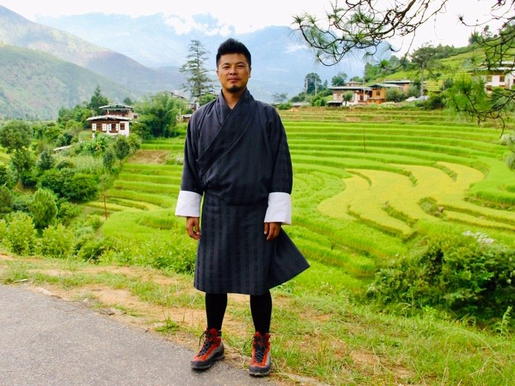 Person in traditional attire, rice terraces.
